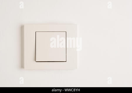 Electric switch with space for text on white wall. Stock Photo