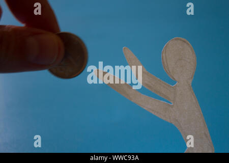 Beggar asks for help. Hand gives money to beggar Stock Photo