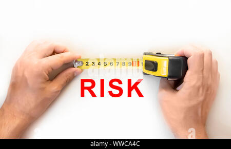 hands holding measure tape measuring risk Stock Photo