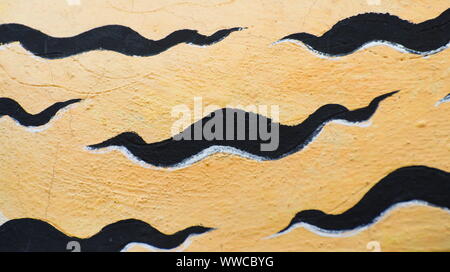 Black stripes on the golden concrete wall background. Stock Photo