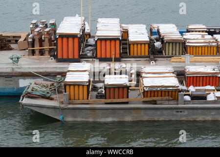 Preparation of fireworks on a barge at sea in a port in Brittany, France Stock Photo