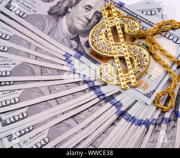 Gold Dollar Sign Necklace on a United States Dollars Banknotes. Stock Photo