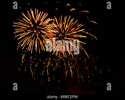 Colorful fireworks of various colors over night sky in Koenigsdorf airfield Stock Photo