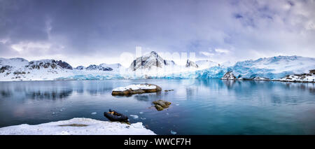 Panarama of the mountains, snow and blue glacial ice of the Smeerenburg glacier, Svalbard, and archipelago between mainland Norway and the North Pole. Stock Photo