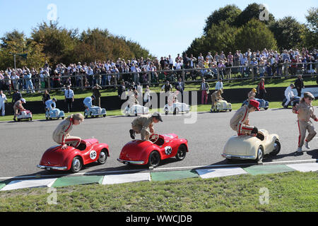 Goodwood, West Sussex, UK. 15th September 2019. Settrington Cup Austin J40 pedal car racers climb into their cars at the running start of the race part 2 at the Goodwood Revival in Goodwood, West Sussex, UK. © Malcolm Greig/Alamy Live News Stock Photo