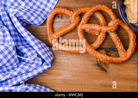 Traditional and pastry brezel for the beer festival. Wood background and decor. View from above Stock Photo