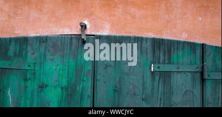 Door made of wooden panels painted and eroded by time, in a rural house, Italy. Stock Photo