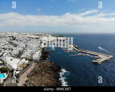 Aerial photo of the beautiful Boats and Boat Harbour Marina and pier taken in Lanzarote in Spain one of the Canary islands, showing all kinds of saili Stock Photo