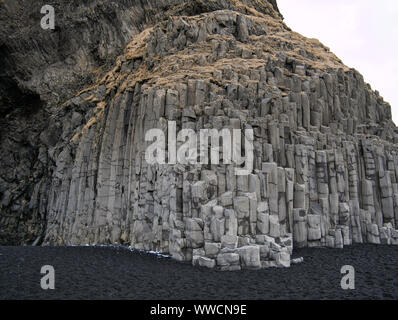 Rock face with basalt stones and black sand in Iceland Stock Photo