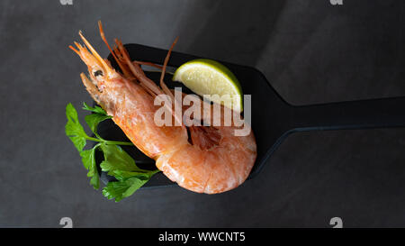 Fine selection of jumbo shrimps with lemon and parsley.