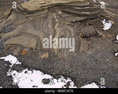 A rock formed by lava in Iceland with snow in March Stock Photo
