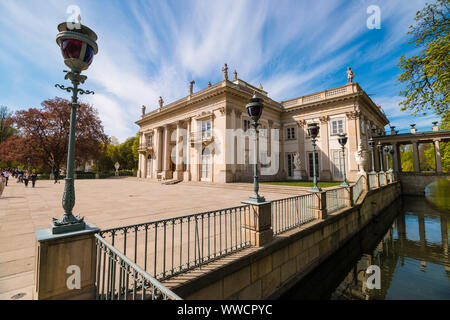 Warsaw, Poland - April 20, 2019: Beautiful Palace on the Water or Lazienki Palace in Lazienki park (Royal Baths park) on a sunny spring day. Stock Photo