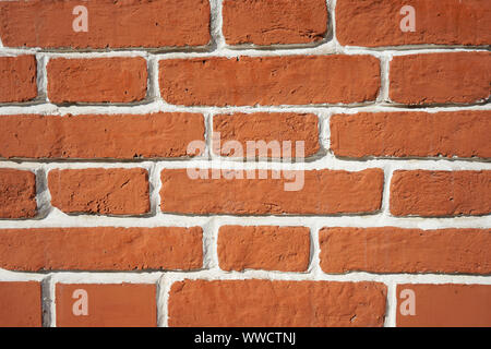 Background brick brown wall with white seams. Stock Photo