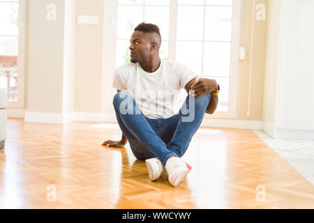 Young hispanic man sitting on wheelchair looking to side, relax profile pose  with natural face and confident smile Stock Photo - Alamy