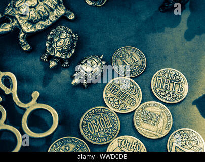 Souvenir metal coins and figurines of turtles. Stock Photo