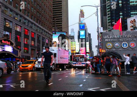 Traffic of pedestrians, cyclists, and cars trudges through Times Square on a rainy afternoon. Manhattan on JULY 31st, 2019 in New York, USA. (Photo by Stock Photo