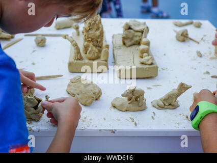 Children's plasticine figurines at the master class on modeling of plasticine. Stock Photo