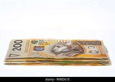 Stack of polish banknotes with two hundred zloties banknote on top on white background Stock Photo