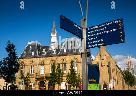 UK, County Durham, Bishop Auckland, Town Hall and tourist information signpost Stock Photo