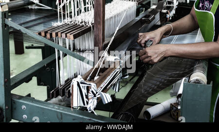 Weave Thai silk. Demonstrate to procedure popular and traditional art. Stock Photo