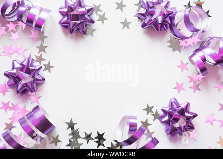 Christmas frame made of fir branches on pink table. Xmas background. Flat lay. Top view with copy space Stock Photo