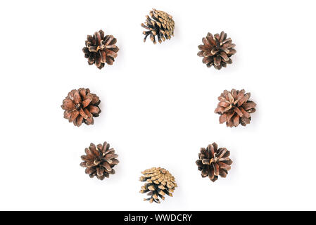 Circle of pine cones on a white background. Natural christmas composition. Holiday card. Flat lay. View from above. Stock Photo