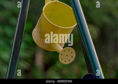 Yellow watering can made of metal Stock Photo