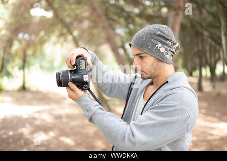 casual man photographer shooting pictures and video edit Stock Photo