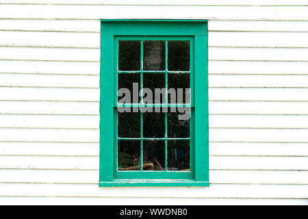 Old rustic green window frame on cedar shingles with weathered peeling Stock Photo