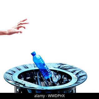 Caucasian hand throwing a bottle of water made of blue plastic into a wastepaper basket. Stock Photo