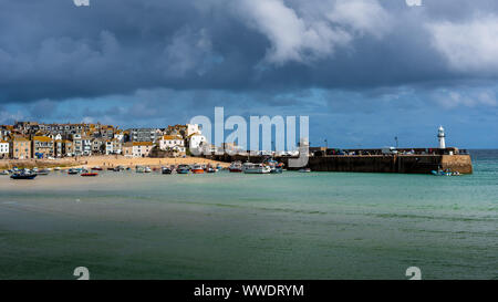 St Ives Harbour Cornwall - Smeaton's Pier and the St Ives Harbour Beach in the Cornish seaside town of St Ives. Stock Photo