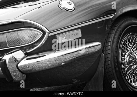 Right side rear quarter detail of a Triumph Stag classic British sports car showing chrome bumper, light cluster and Stag badge. Stock Photo