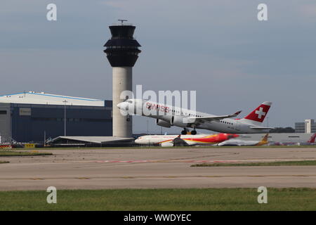 Swiss A220 taking off at Manchester Airport on 23R past the nats/natsaero tower. Stock Photo