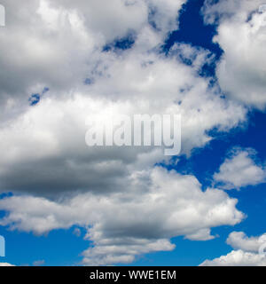 White fluffy clouds in a dark blue sky Stock Photo