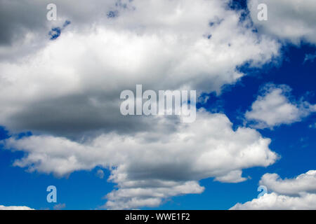 White fluffy clouds in a dark blue sky Stock Photo