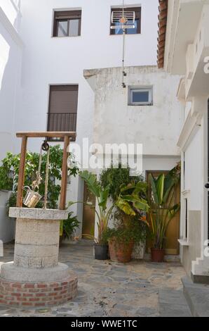 Well at white corner in Casares, a  mountain village of Malaga province, Andalusia, Spain. Stock Photo