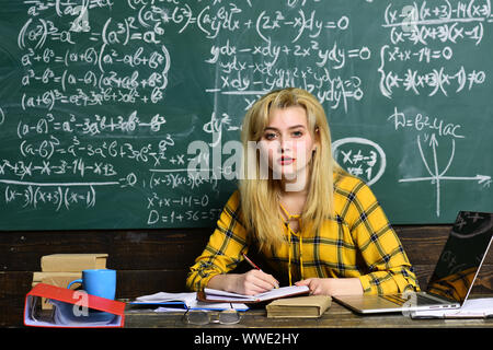 Students usually get excited about the material. Students prepare for success this school year. Teacher in glasses reading reports of talented Stock Photo