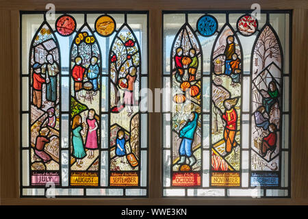 Stained glass window depicting Labours of the Month on display in Godalming Museum, Surrey, UK Stock Photo