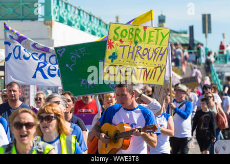 Brighton, East Sussex, UK. 15th Sep, 2019. The South coast recovery walk 'Cascade creative recovery' is a charity helping people recover from Alcohol or drug abuse providing a welcoming and supportive environment for people directly involved in addiction. Slogans include 'sobriety through creativity and sobriety is healthy' as groups of people walk along the seafront promenade. © Paul Lawrenson 2019, Photo Credit: Paul Lawrenson / Alamy Live News Stock Photo