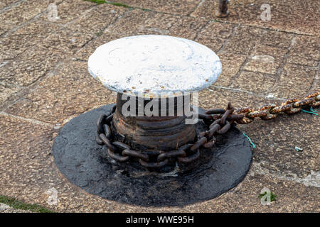 Ship's Red Mooring Bollards at Looe Harbour and White Bollards with Chain at Mevagissey in Cornwall  UK Stock Photo