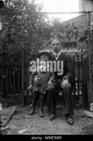AJAXNETPHOTO. 1889-1900 (APPROX). FRANCE (EXACT LOCATION UNKNOWN.). - FAMILY SNAPSHOT - MAN SEATED WITH YOUNG BOY IN FENCED GARDEN ENVIRONMENT. IMAGE FROM ORIGINAL GLASS PLATE NEGATIVE; DATE SOURCE FROM GLASS PLATE BOX LID.  PHOTOGRAPHER:UNKNOWN © DIGITAL IMAGE COPYRIGHT AJAX VINTAGE PICTURE LIBRARY SOURCE: AJAX VINTAGE PICTURE LIBRARY COLLECTION REF:AVL PEO FRA 1889 101