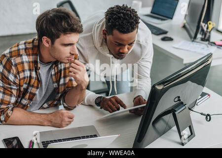 two serious multicultural programmers working in office together Stock Photo