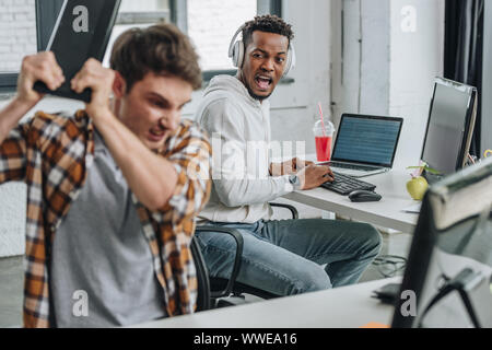 selective focus of african american programming yelling at angry colleague Stock Photo