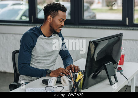 handsome african american programmer working on computer in office Stock Photo