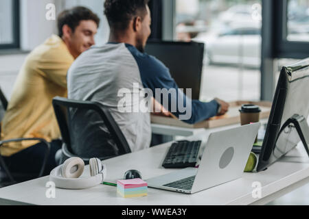 back view of african american programmer working in office together with colleague Stock Photo