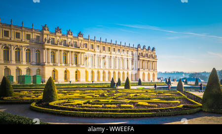 Famous palace Versailles with beautiful gardens outdoors near Paris, France. The Palace Versailles was a royal chateau and was added to the UNESCO Stock Photo