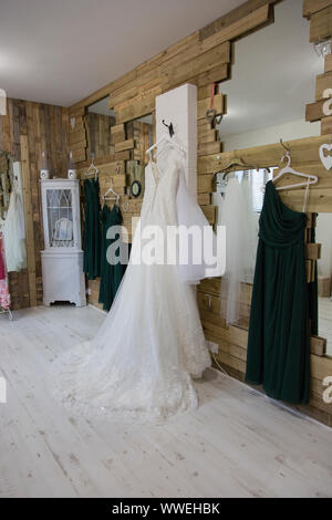 bride and bridesmaids dresses hanging on hangers Stock Photo - Alamy