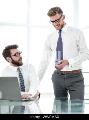 two employees discuss business issues near the office Desk Stock Photo