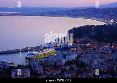 NICE, FRANCE -16 APR 2018- Sunset view of a ferryboat from Corsica Sardinia Ferries in the Port of Nice and the Promenade des Anglais waterfront on th Stock Photo