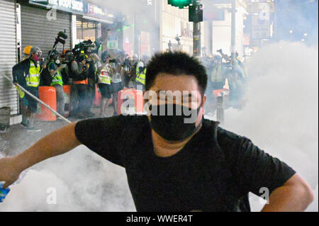 A protester flees from a cloud of tear gas fired by riot police in Causeway Bay in Hong Kong on Sunday, September 15, 2019. Photo by Thomas Maresca/UPI Credit: UPI/Alamy Live News Stock Photo